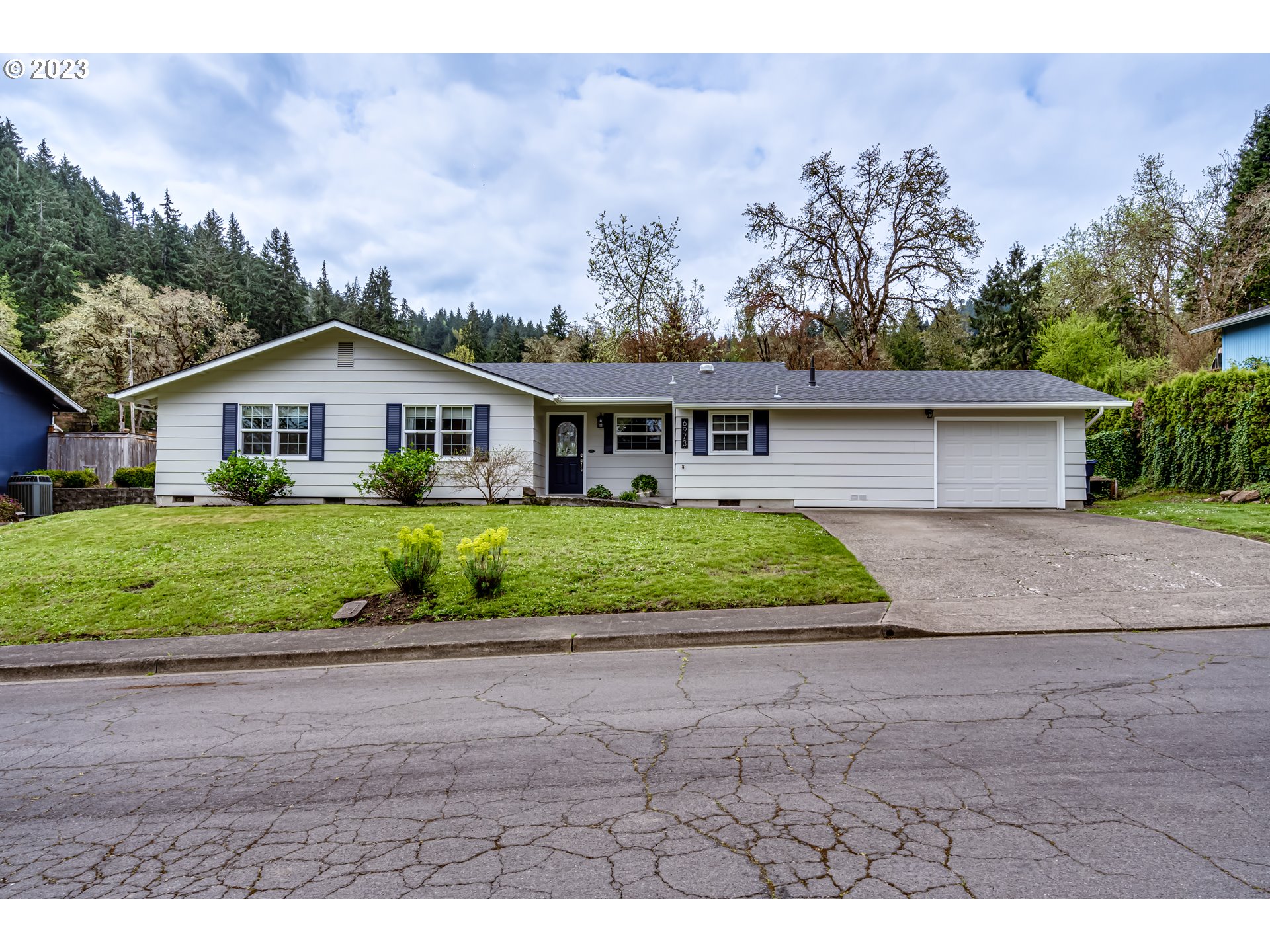 6973 Glacier Drive Springfield, OR 97478 - Photo 2 of 34 a view of house with a yard and potted plants