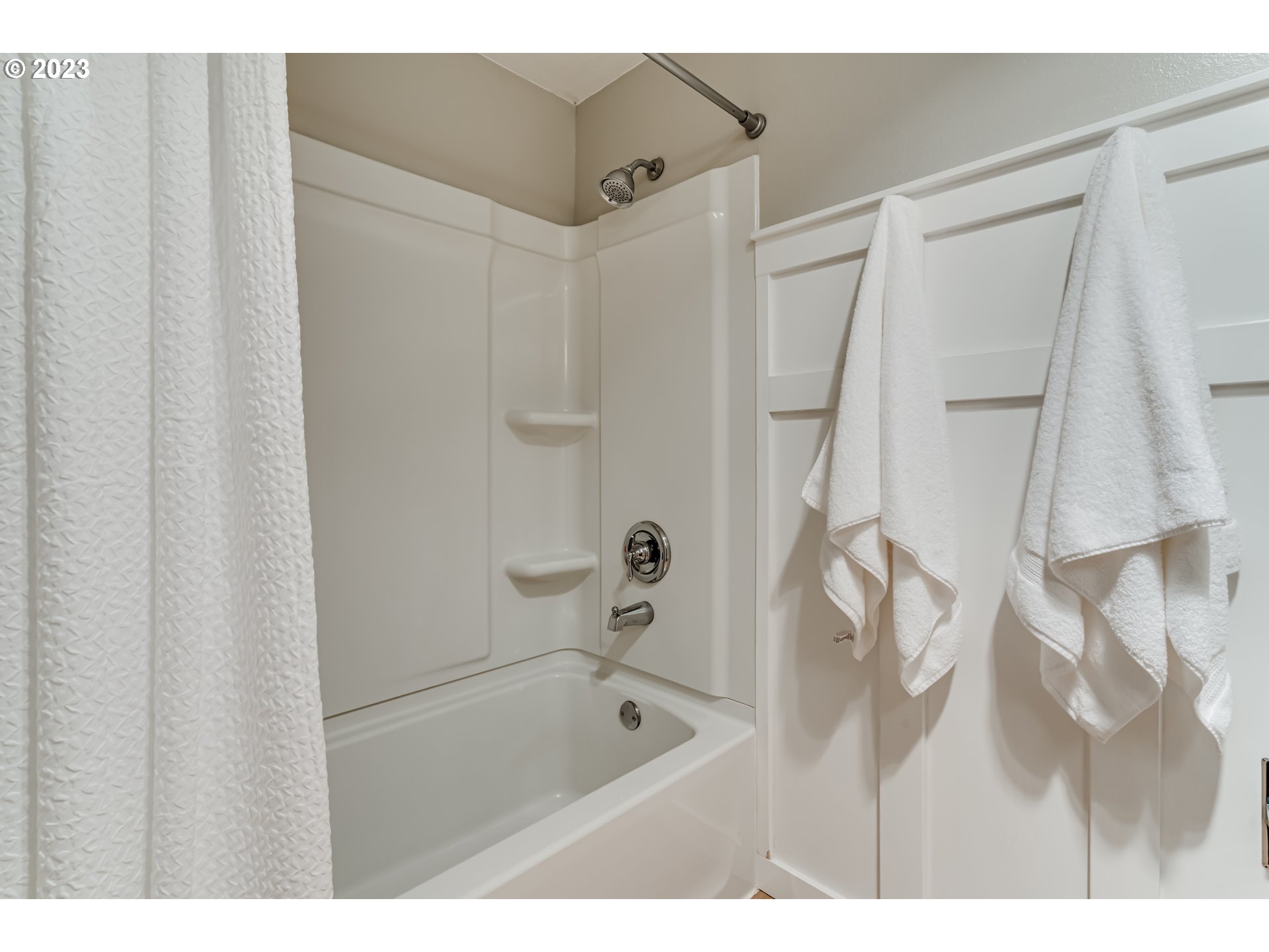 6973 Glacier Drive Springfield, OR 97478 - Photo 23 of 34 a bathroom with a tub shower vanity and a sink