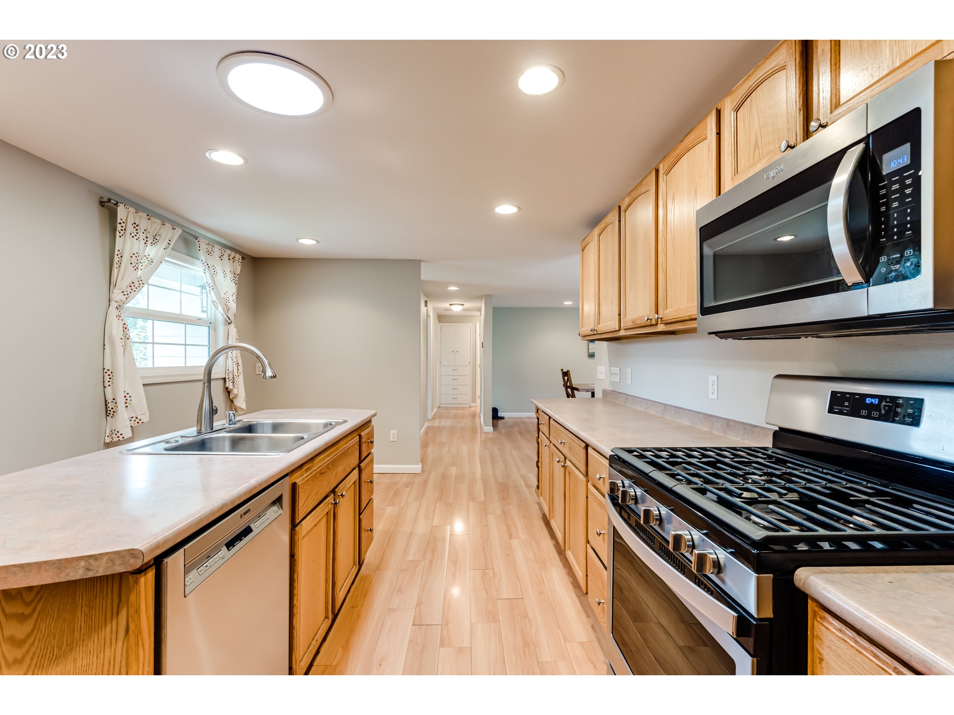 6973 Glacier Drive Springfield, OR 97478 - Photo 8 of 34 a kitchen with kitchen island granite countertop a sink stainless steel appliances and cabinets