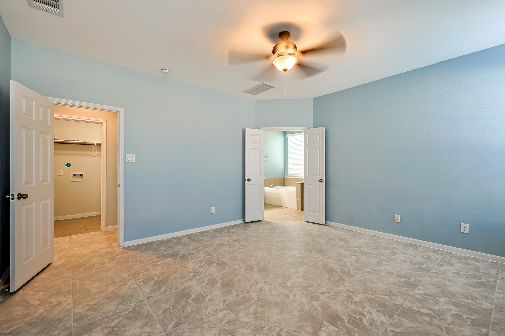 6014 Watford Bend Rosenberg, TX 77471 - Photo 12 of 36 a view of a room with a chandelier fan and a bathroom