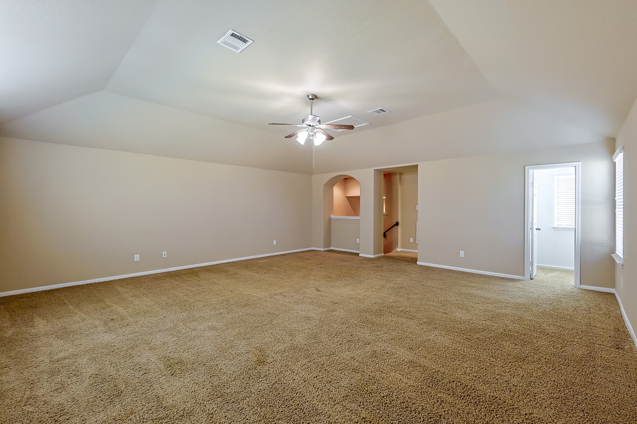 6014 Watford Bend Rosenberg, TX 77471 - Photo 28 of 36 an empty room with a chandelier fan and windows