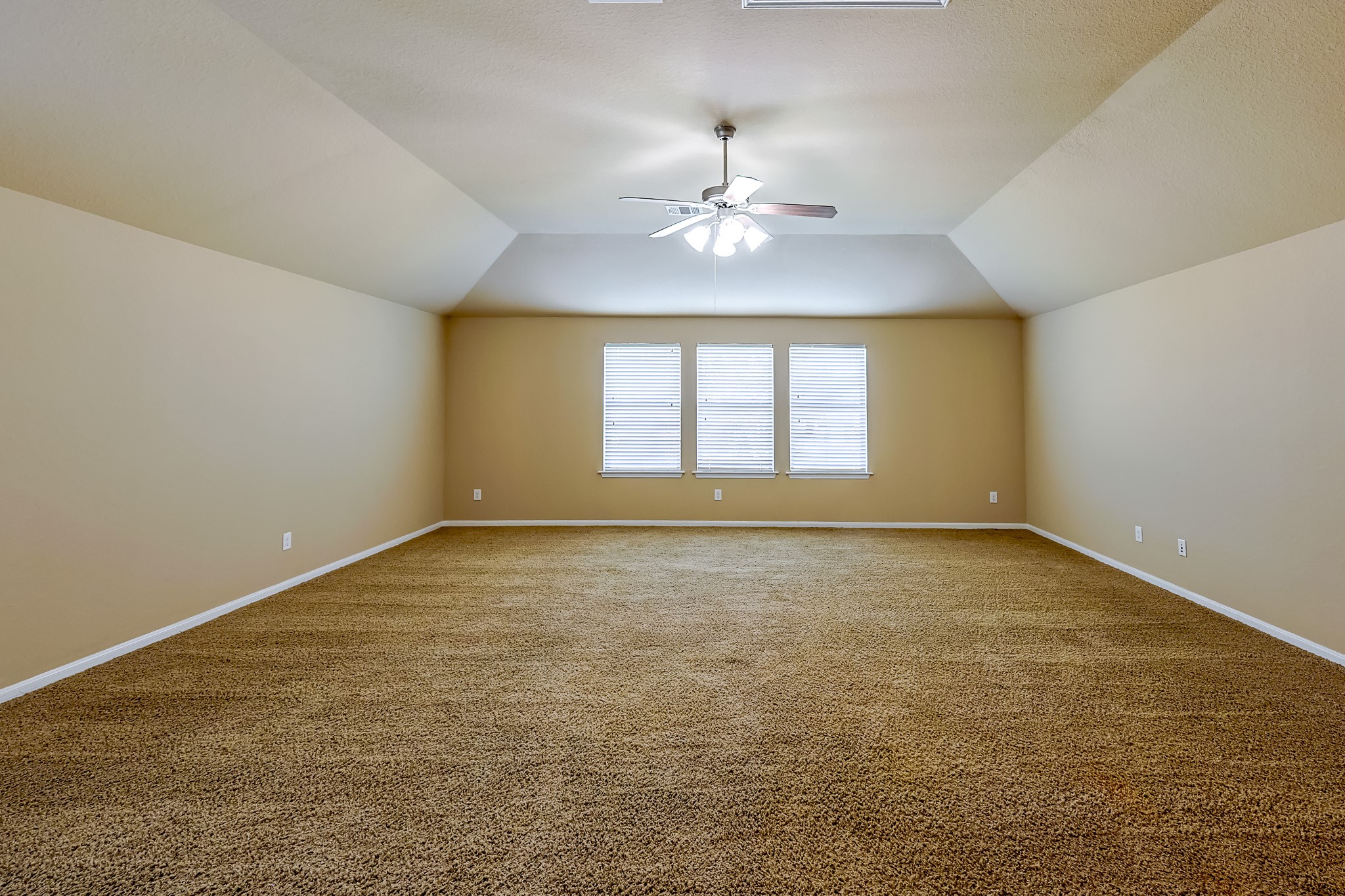 6014 Watford Bend Rosenberg, TX 77471 - Photo 29 of 36 an empty room with a chandelier fan and windows