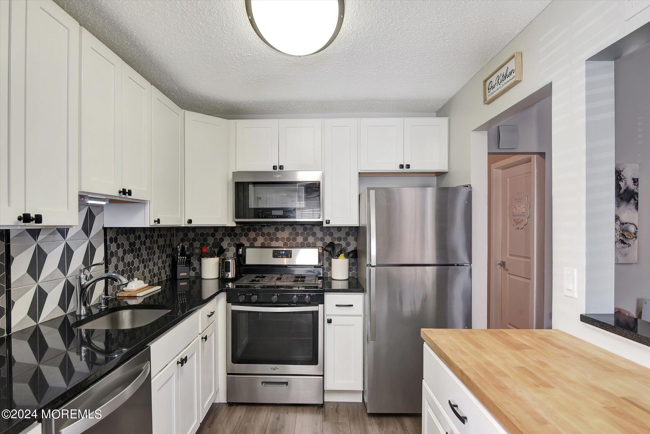 116 Azalea Circle Jackson, NJ 08527 - Photo 16 of 37 a kitchen with a refrigerator and a sink