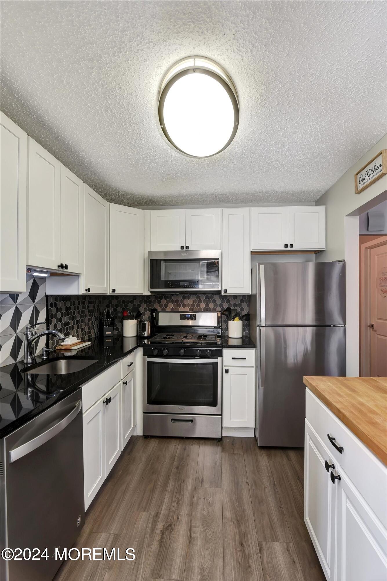 116 Azalea Circle Jackson, NJ 08527 - Photo 17 of 37 a kitchen with a sink a stove and refrigerator