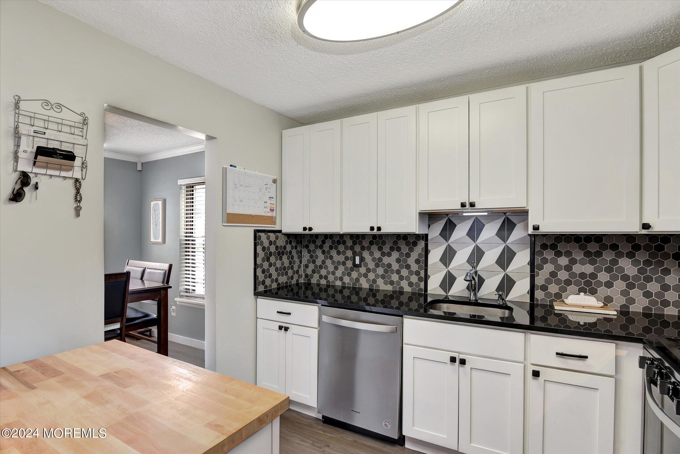 116 Azalea Circle Jackson, NJ 08527 - Photo 19 of 37 a kitchen with stainless steel appliances white cabinets and a refrigerator