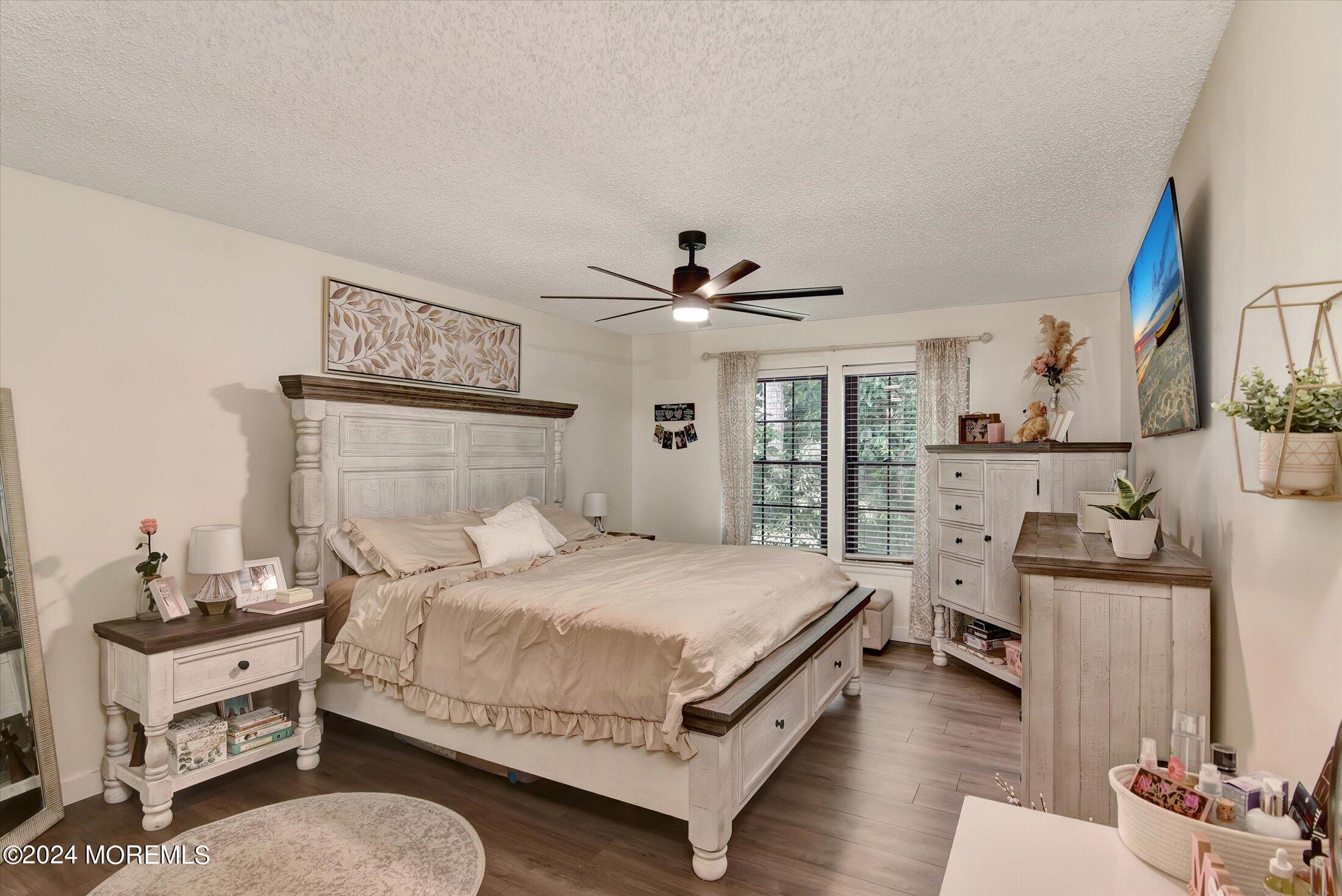 116 Azalea Circle Jackson, NJ 08527 - Photo 27 of 37 a bedroom with a bed and wooden floor