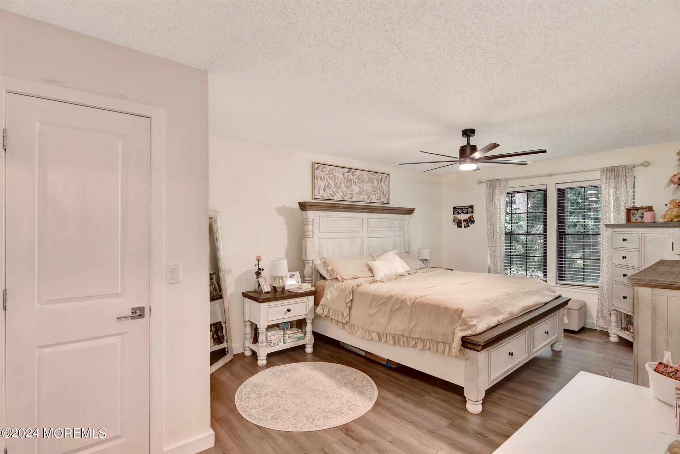 116 Azalea Circle Jackson, NJ 08527 - Photo 28 of 37 a bedroom with a bed and wooden floor