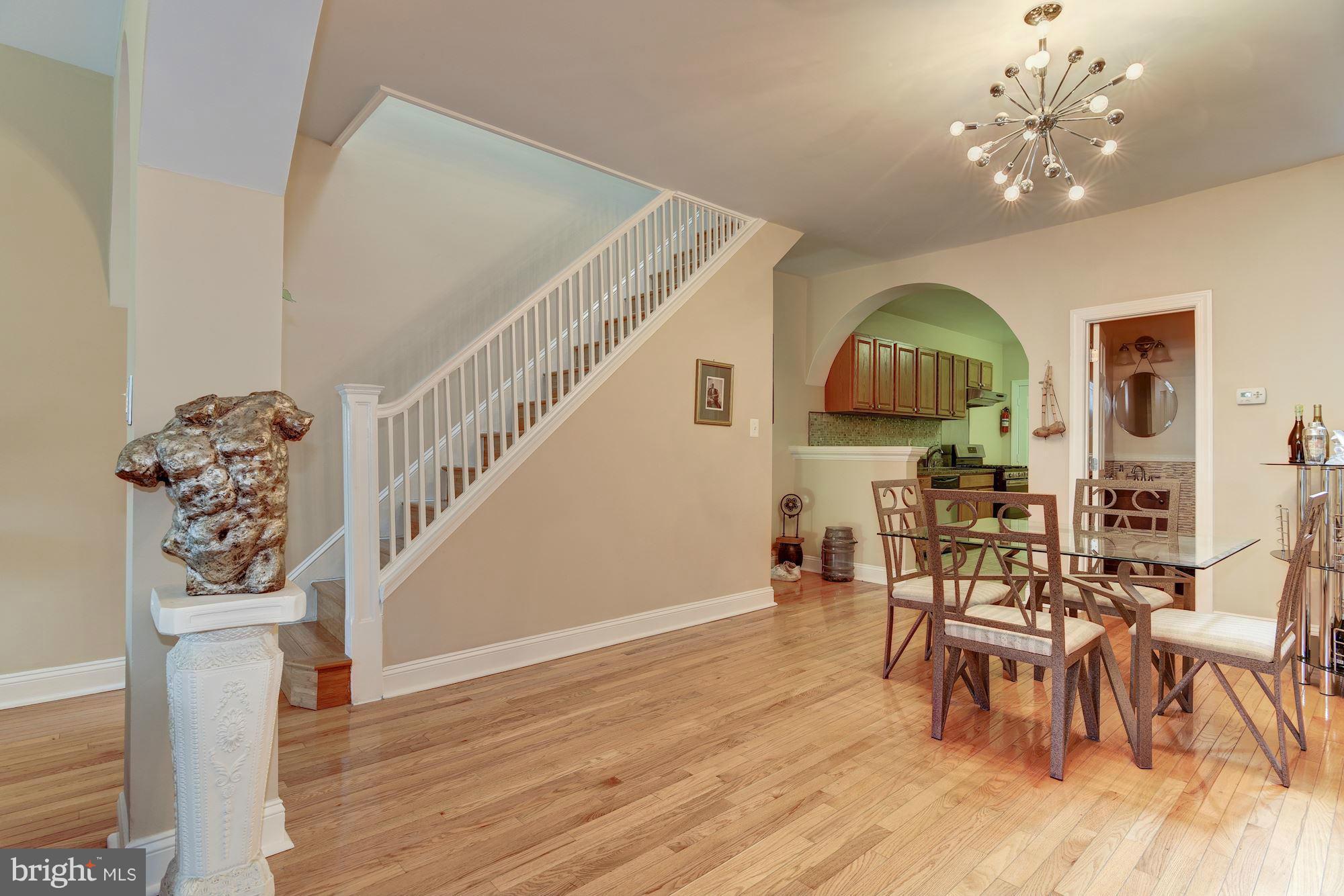 3633 13th Street Northwest Washington, DC 20010 - Photo 11 of 30 a view of a dining room with furniture a chandelier and wooden floor