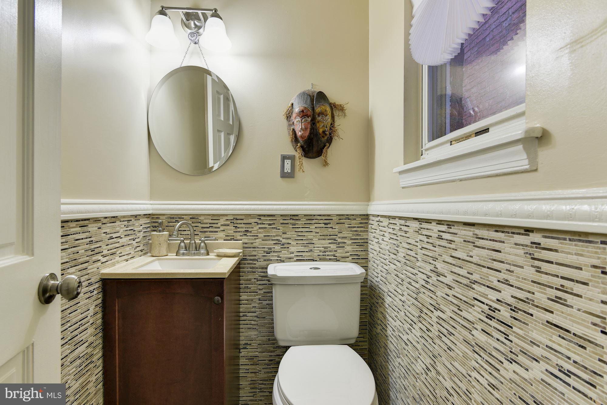 3633 13th Street Northwest Washington, DC 20010 - Photo 12 of 30 a bathroom with a toilet a sink and mirror