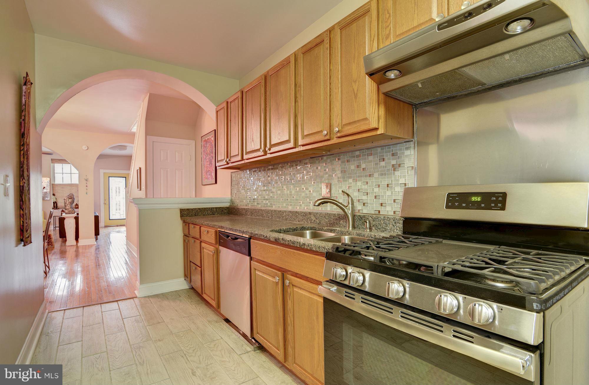 3633 13th Street Northwest Washington, DC 20010 - Photo 13 of 30 a kitchen with stainless steel appliances granite countertop a stove and a sink