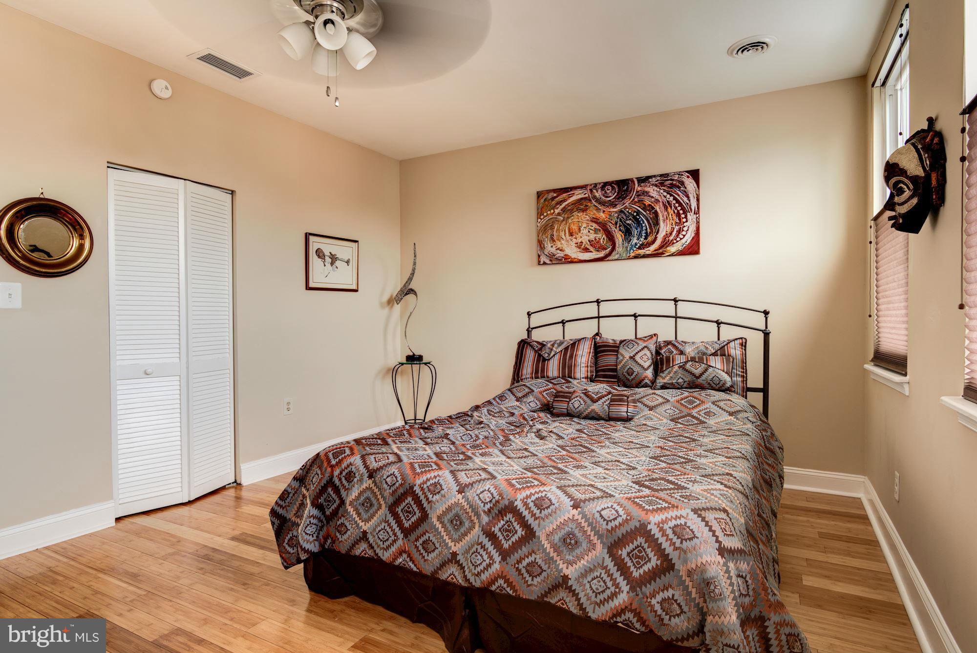 3633 13th Street Northwest Washington, DC 20010 - Photo 17 of 30 a bedroom with a bed and a chandelier