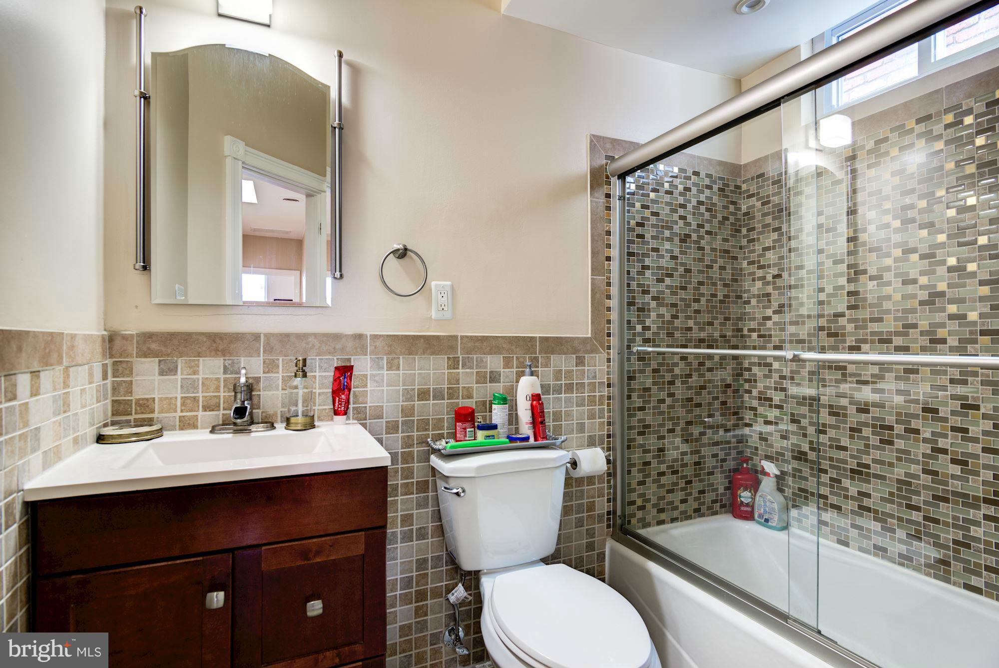 3633 13th Street Northwest Washington, DC 20010 - Photo 20 of 30 a bathroom with a sink toilet and a mirror