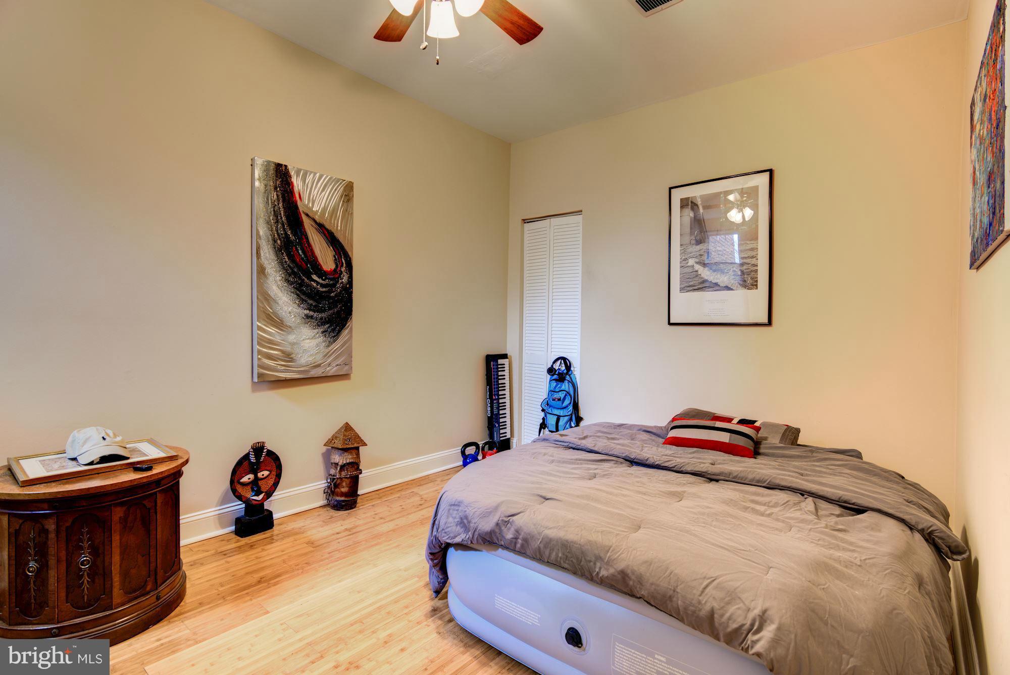 3633 13th Street Northwest Washington, DC 20010 - Photo 21 of 30 a bedroom with a bed and a chandelier
