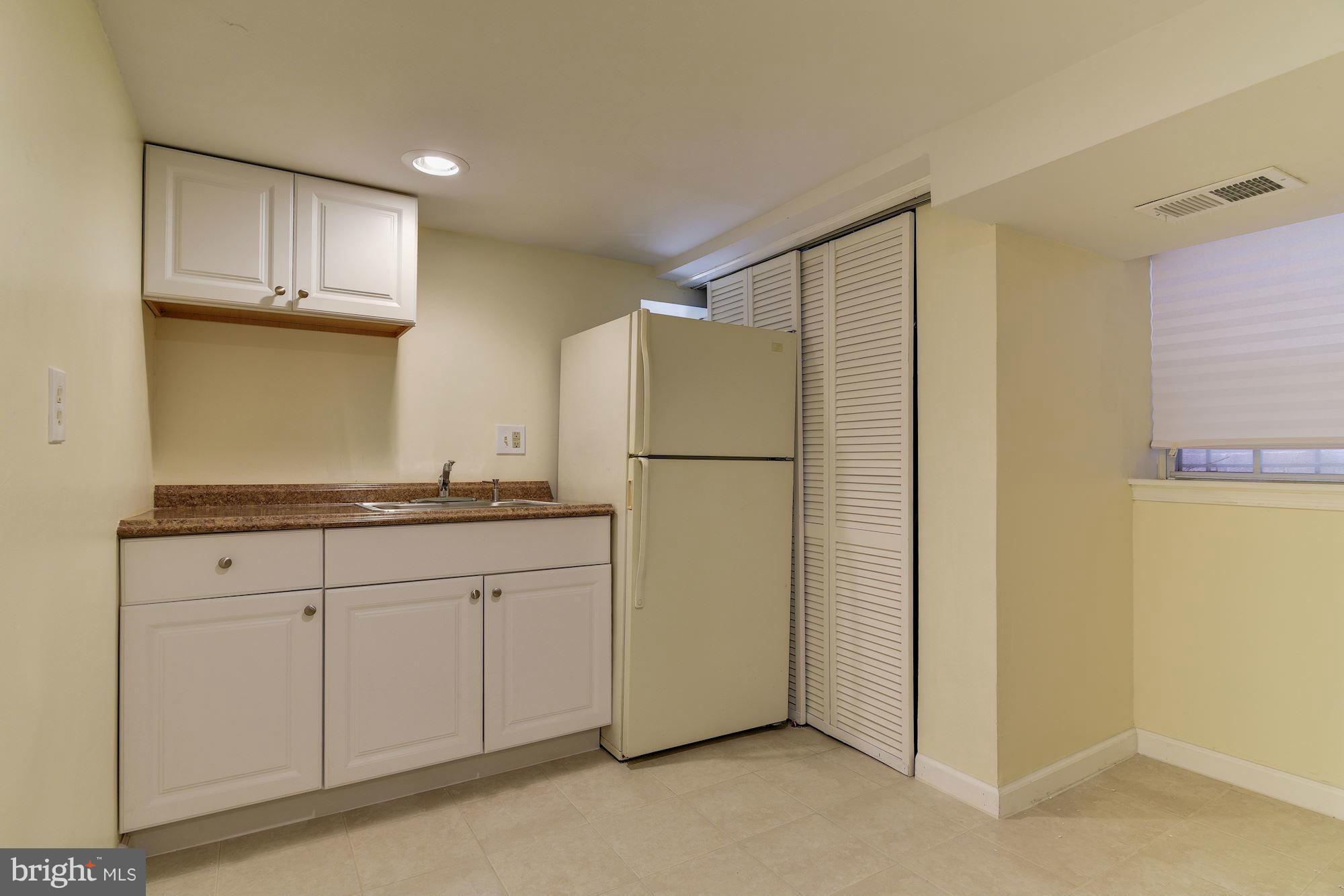 3633 13th Street Northwest Washington, DC 20010 - Photo 28 of 30 a kitchen with sink cabinets and refrigerator