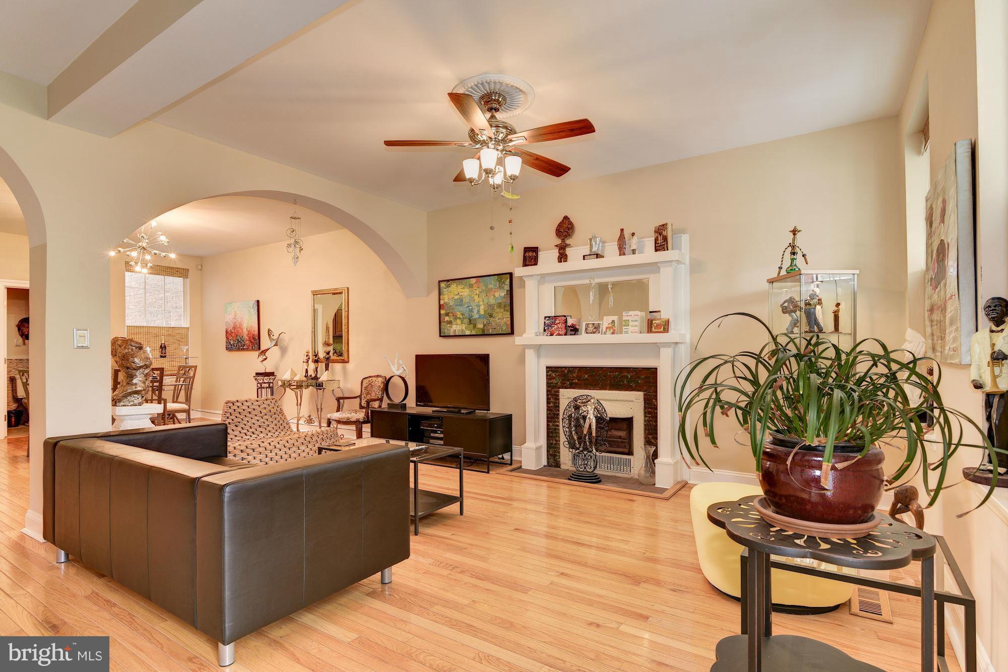 3633 13th Street Northwest Washington, DC 20010 - Photo 8 of 30 a living room with furniture a fireplace and a potted plant