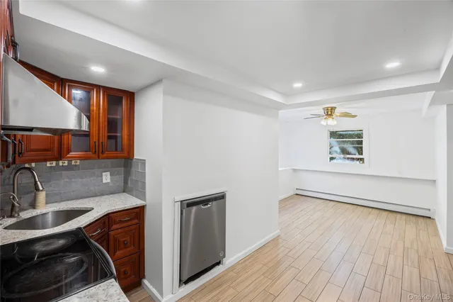 a view of a kitchen with a sink and wooden floor