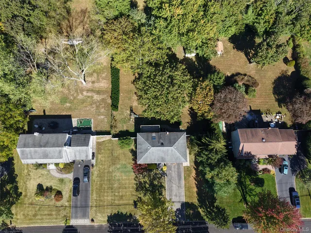 an aerial view of residential houses with outdoor space and parking