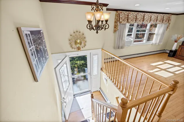 a view of entryway with wooden floor and stairs