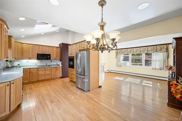 a view of a kitchen with a sink stainless steel appliances and cabinets
