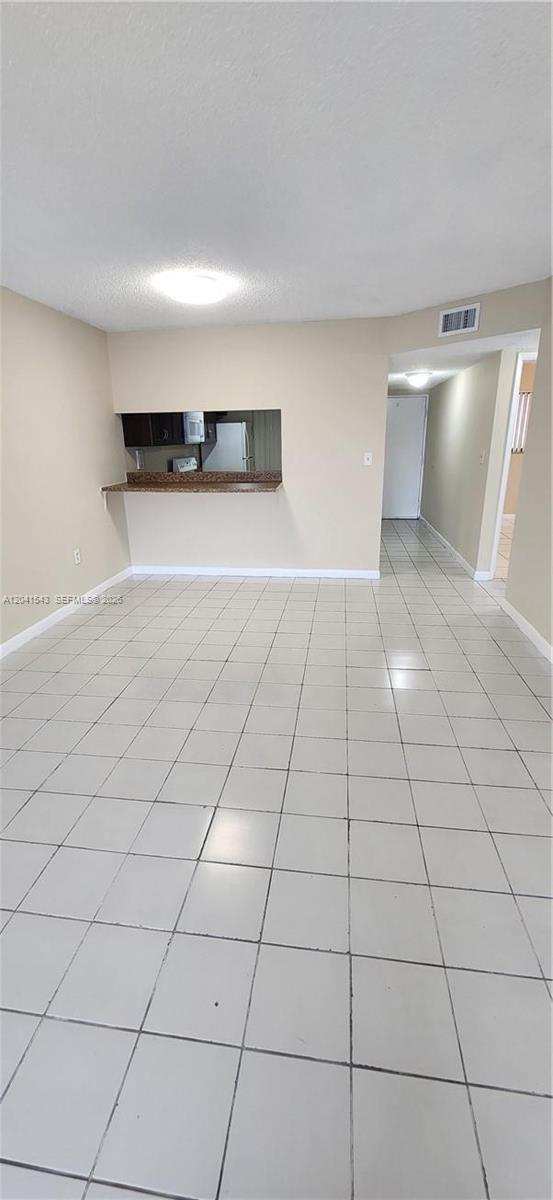 9915 West Okeechobee Road, Unit 2404 Hialeah Gardens, FL 33016 - Photo 5 of 5 a view of a livingroom with an empty space and a window