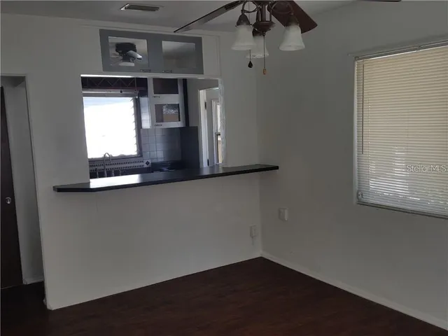 a kitchen with granite countertop a stove and a microwave