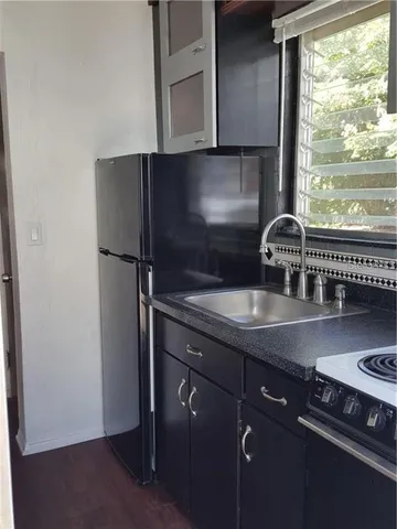 a bathroom with a sink toilet and a window