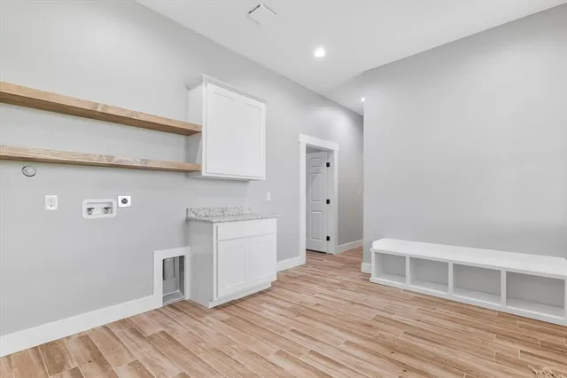 a view of a kitchen with wooden floor and a sink