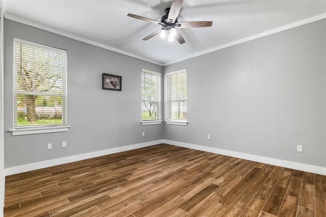wooden floor in an empty room with a window