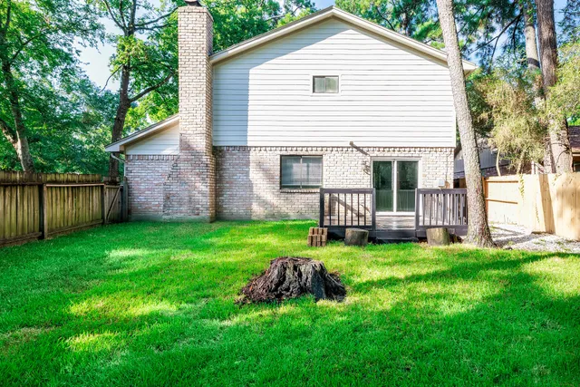 a view of a house with a yard and deck