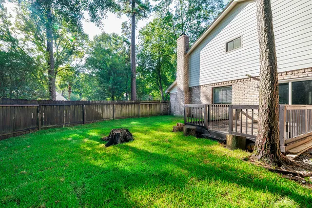 a view of backyard with deck and garden