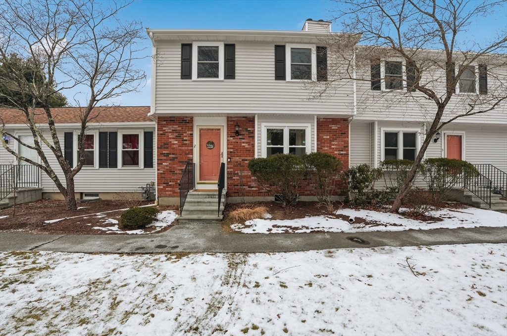 a front view of a house with trees