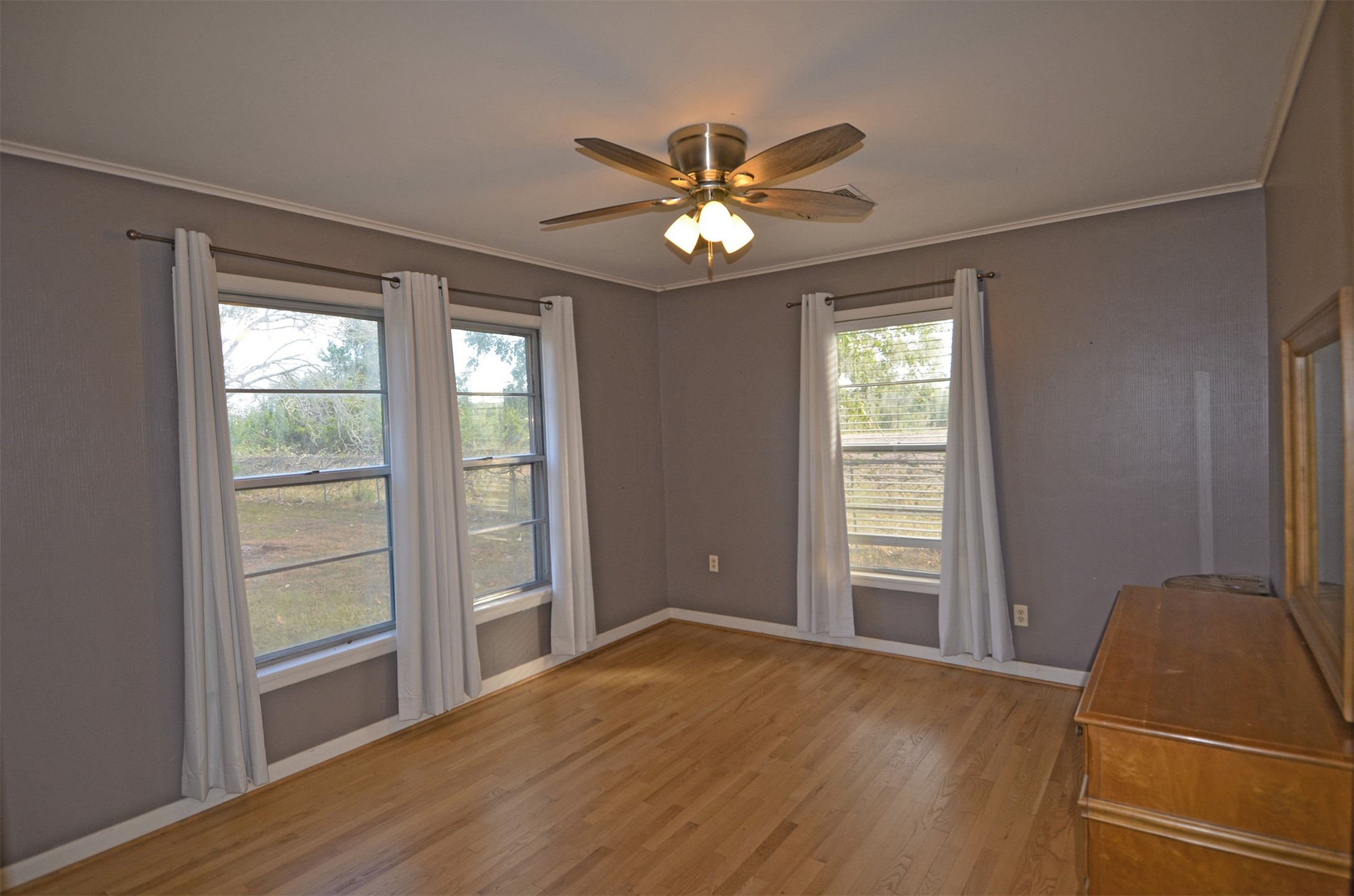 2352 Airport Road Brenham, TX 77833 - Photo 13 of 26 wooden floor in an empty room with a window