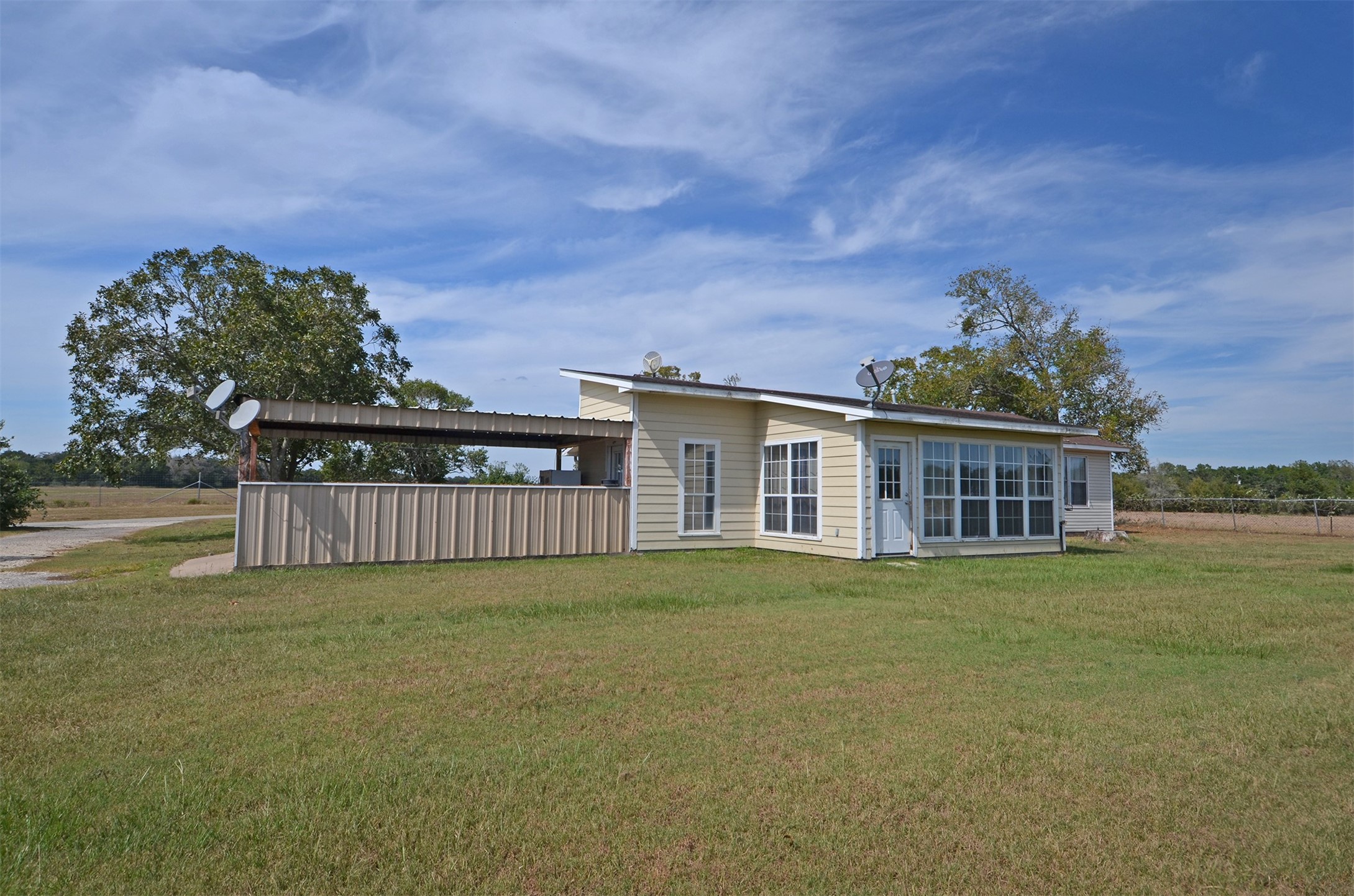 2352 Airport Road Brenham, TX 77833 - Photo 7 of 26 a front view of a house with a garden