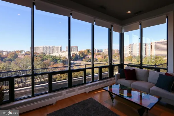 a living room with furniture and a floor to ceiling window