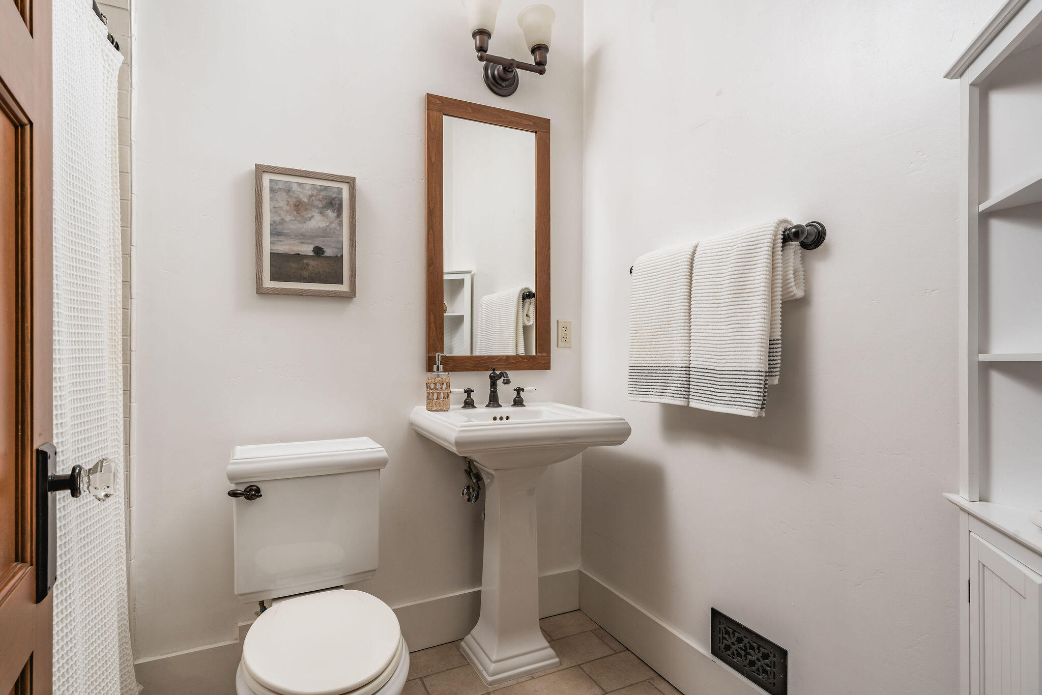 1436 Laguna Street Santa Barbara, CA 93101 - Photo 9 of 21 a bathroom with a sink a toilet and mirror