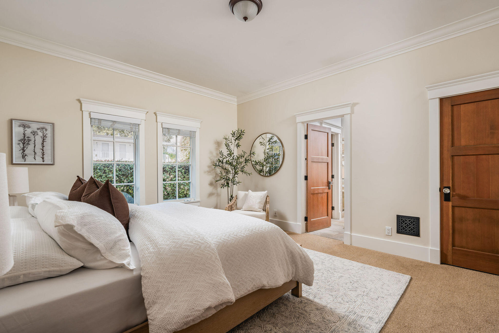 1436 Laguna Street Santa Barbara, CA 93101 - Photo 6 of 21 a bedroom with a large bed and a chandelier