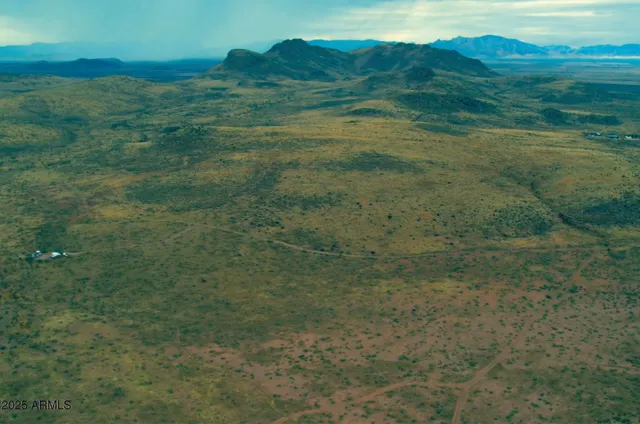 a view of a field with an ocean view