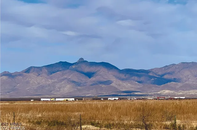a view of an ocean with mountains in the background