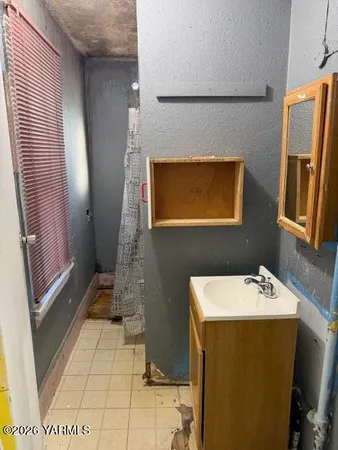 a bathroom with a sink a toilet and mirror