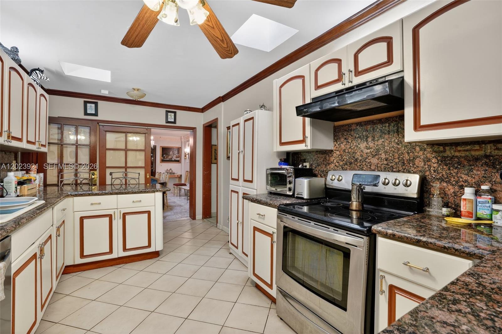 8461 Southwest 68th St Road Miami, FL 33143 - Photo 55 of 65 a kitchen with stainless steel appliances granite countertop a stove and a sink