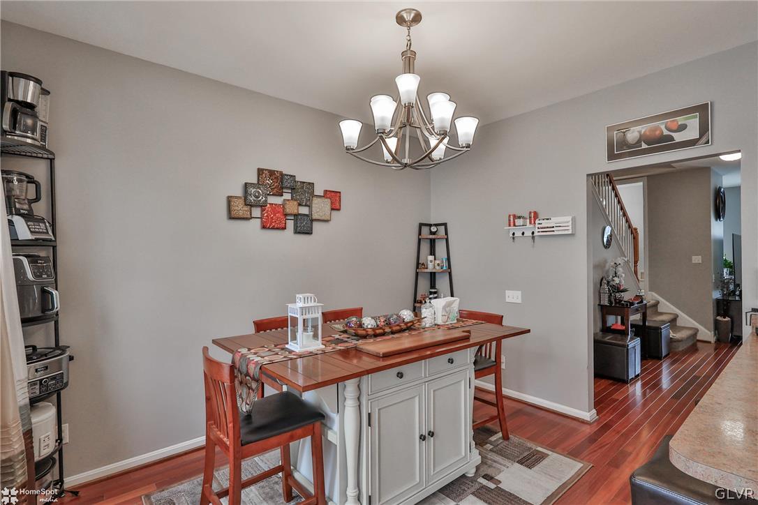 8550 Gateway Road Breinigsville, PA 18031 - Photo 14 of 50 a view of a dining room with furniture wooden floor and a chandelier