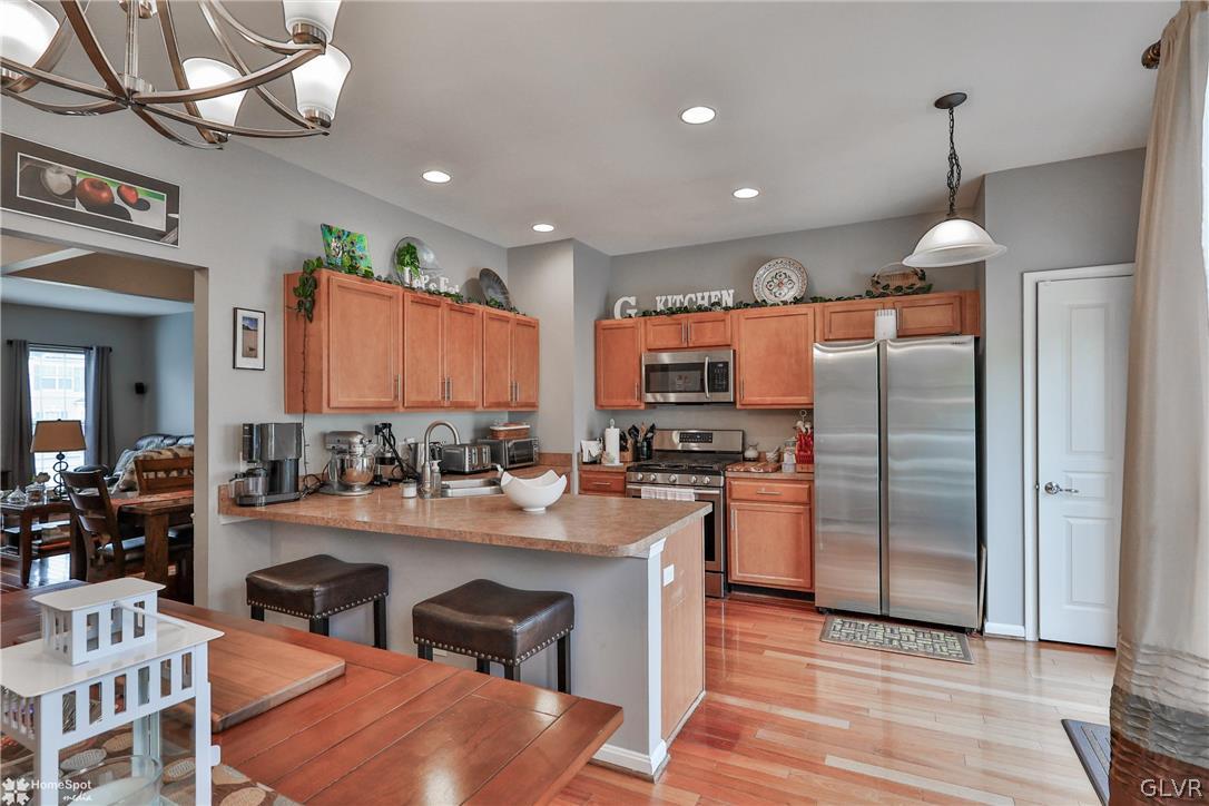 8550 Gateway Road Breinigsville, PA 18031 - Photo 15 of 50 a kitchen with stainless steel appliances granite countertop a sink refrigerator and cabinets