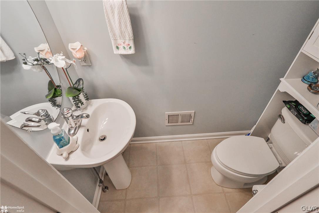 8550 Gateway Road Breinigsville, PA 18031 - Photo 30 of 50 a bathroom with a sink a toilet and mirror