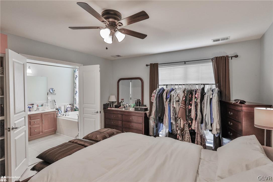 8550 Gateway Road Breinigsville, PA 18031 - Photo 32 of 50 a bedroom with a bed and a chandelier