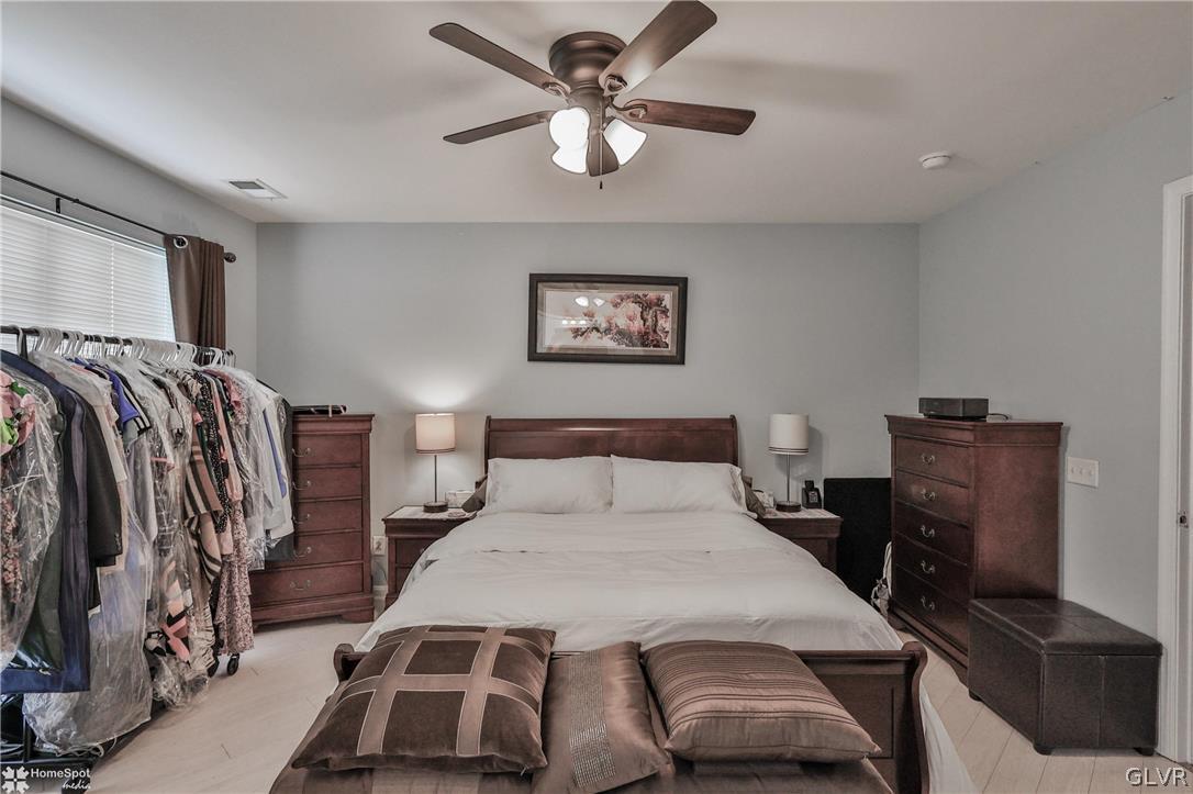 8550 Gateway Road Breinigsville, PA 18031 - Photo 33 of 50 a bedroom with a bed and a chandelier