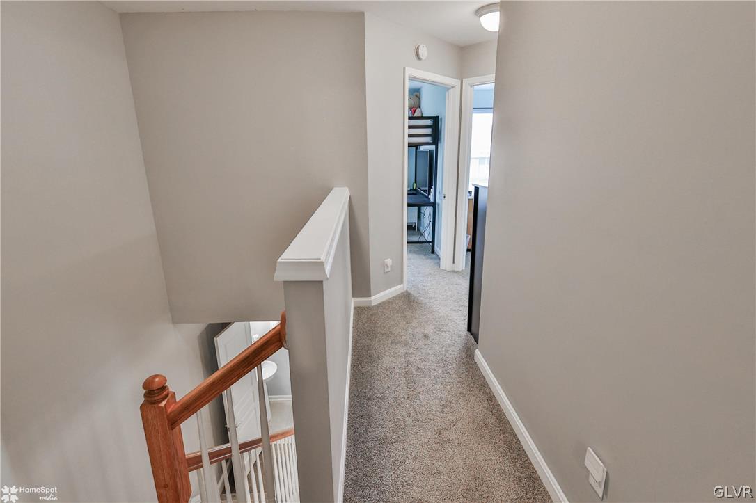 8550 Gateway Road Breinigsville, PA 18031 - Photo 35 of 50 a view of a hallway with wooden floor and stairs
