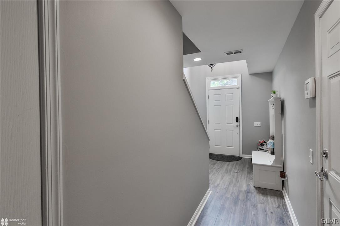 8550 Gateway Road Breinigsville, PA 18031 - Photo 7 of 50 a view of a hallway with wooden floor and a bathroom