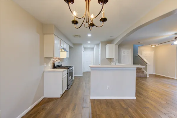 a view of kitchen with granite countertop cabinets counter top space and stainless steel appliances