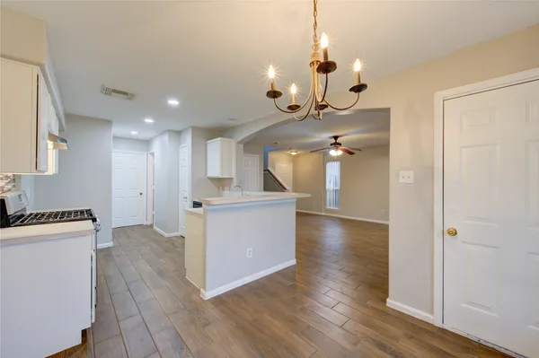 a view of a kitchen with a sink and a refrigerator