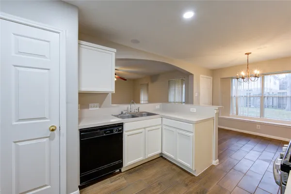 a kitchen with a sink stove and cabinets